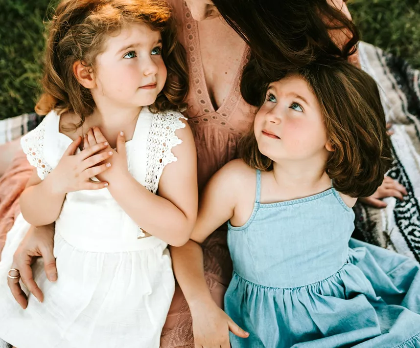 Niñas con vestidos tumbadas en la hierba